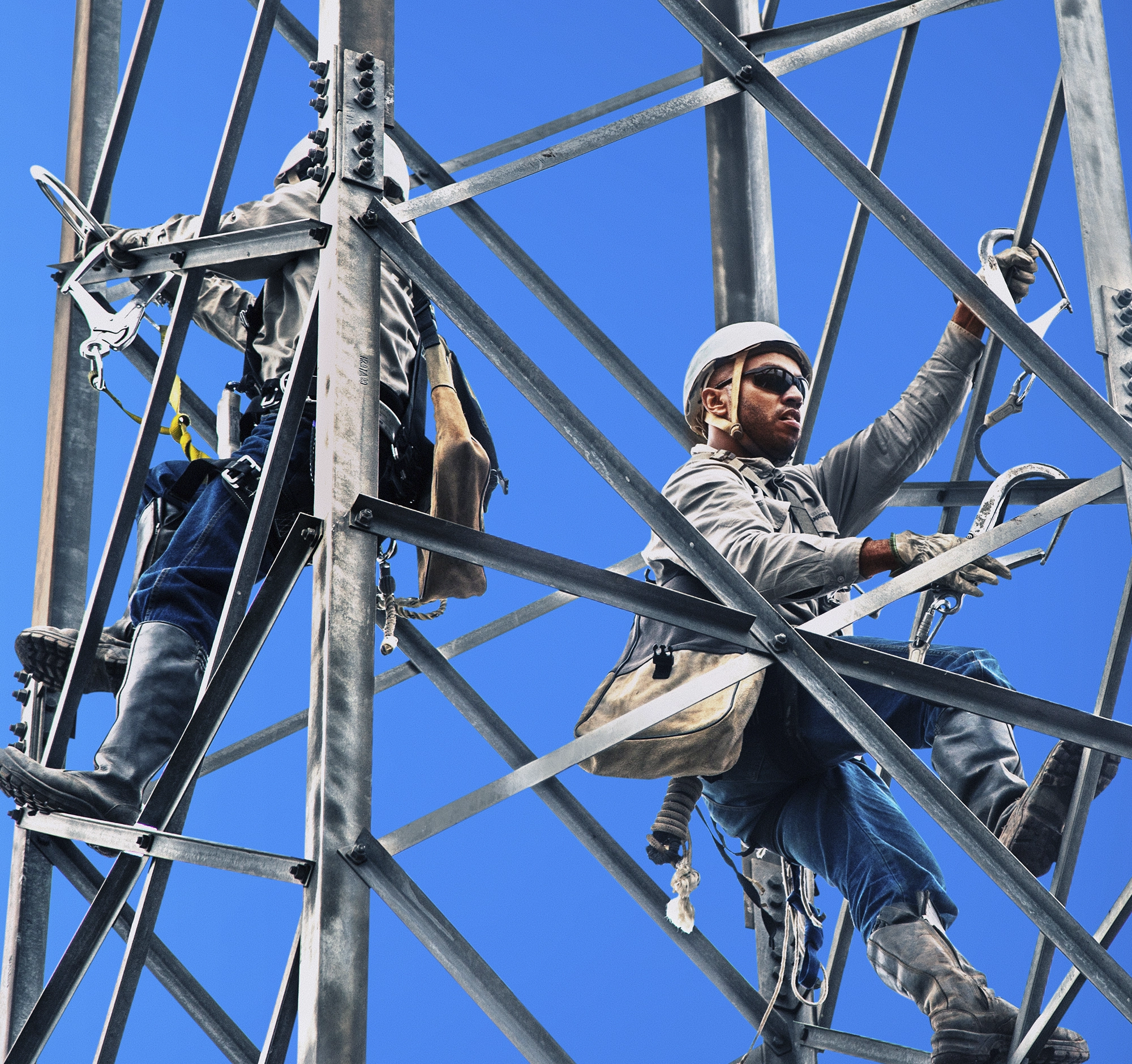 two tecnics on tower