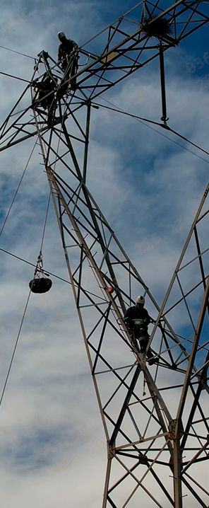 Trabalhadores em torre metálica de transmissão durante atividade na estrutura.